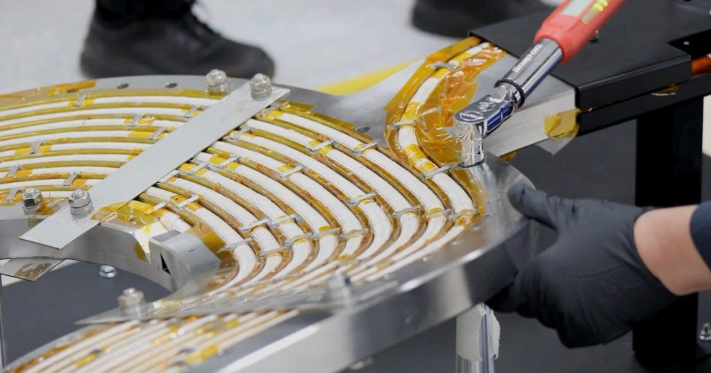 An engineer works on a high-temperature superconducting magnet.