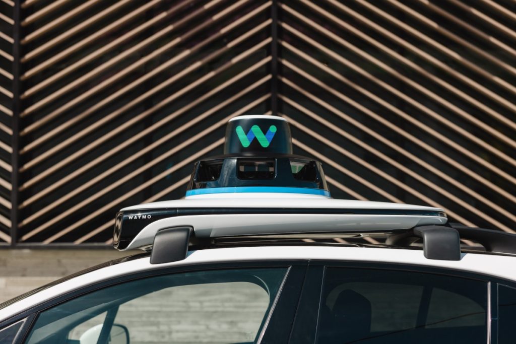The price gap between Waymo and Uber is narrowing top of Waymo car, showing equipment on roof