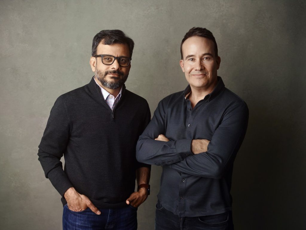 Kana emerges from stealth with $15M to build flexible AI agents for marketers a picture showing the co-founders of Kana, Tom Chavez and Vivek Vaidya, leaning against a grey background