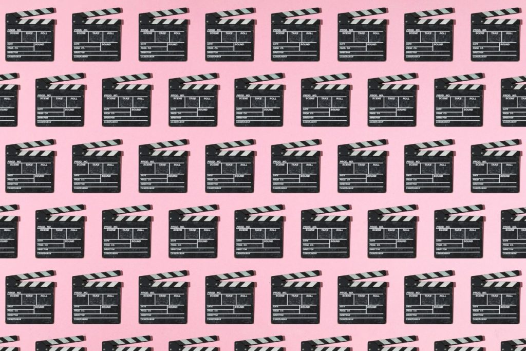 Wooden old movie clapperboard pattern with hard shadow on pink background. Concept of film industry, cinema, entertainment, and Hollywood.