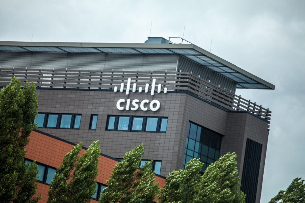 Cisco says hackers have been exploiting a critical bug to break into big customer networks since 2023 Cisco signage on side of building